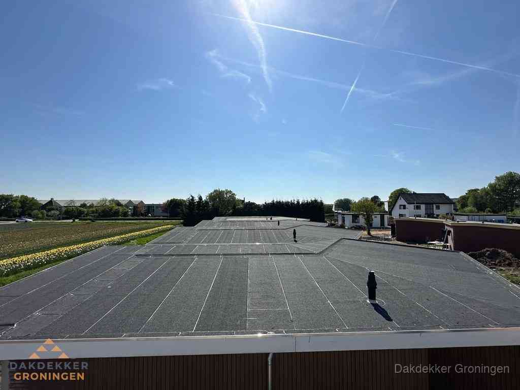Groot plat dak met bitumen dakbedekking op bedrijfspand in Groningen Groot plat dak met bitumen dakbedekking op bedrijfspand in Groningen